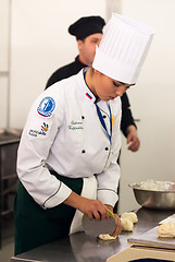 Image showing Girl-cook prepares food in competition