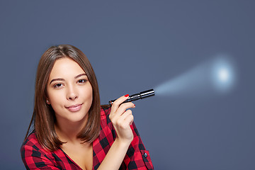 Image showing Closeup of smiling female holding pocket flashlight