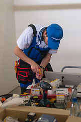 Image showing Young electrician performs task of competition