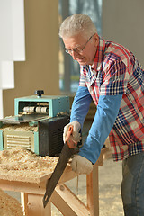 Image showing Senior man  repairing in the room