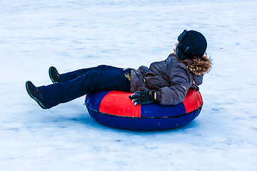 Image showing Baby winter sledding on the Ural River