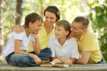 Image showing Family of four reading 