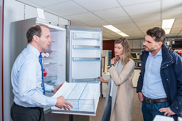 Image showing Assistant Demonstrates Refrigerator To Young Couple