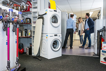 Image showing Salesman Assisting Couple In Buying Refrigerator