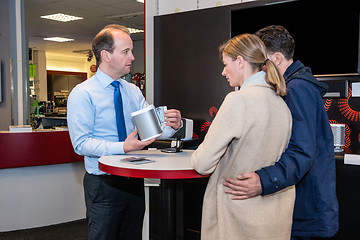 Image showing Salesman Showing Compact Speaker To Couple In Shop