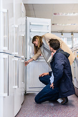 Image showing Couple Buying Domestic Refrigerator In Hypermarket