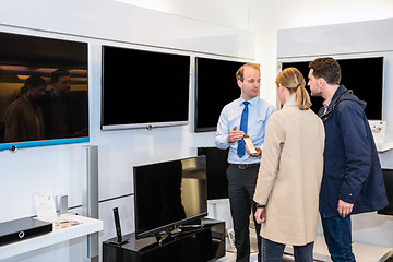 Image showing Salesman Showing Flat Screen Television To Couple In Store