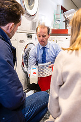 Image showing Salesman Showing Cartridge Of Washing Machine In Store