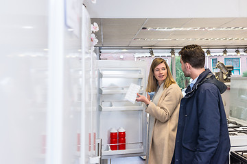 Image showing Young Couple Buying Refrigerator In Hypermarket