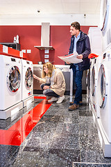 Image showing Couple Choosing Washing Machine In Hypermarket