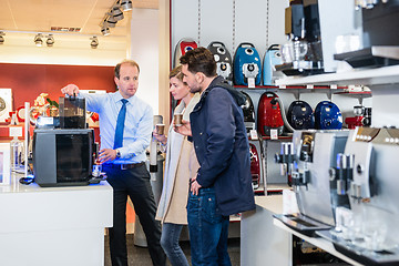 Image showing Salesman Showing Coffee Maker To Couple In Store