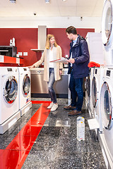 Image showing Couple Choosing Washing Machine In Hypermarket