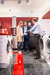 Image showing Salesman Explaining Product Quality At Appliances Store