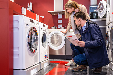 Image showing Couple Choosing Washing Machine At Hypermarket