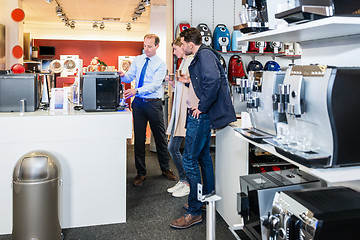 Image showing Salesman Demonstrating Coffee Maker To Couple In Store