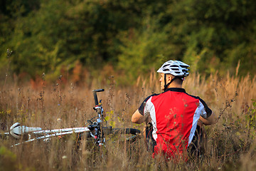 Image showing man repairing his mountain bike