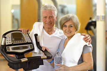 Image showing senior couple exercising in gym