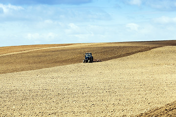 Image showing tractor plowing the fields  