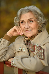 Image showing senior woman in  autumn park