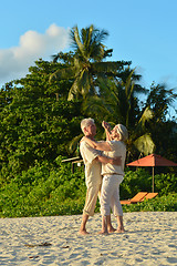 Image showing elderly couple dancing at tropical beach