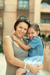 Image showing Mother with  daughter near hotel