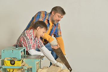 Image showing father and little boy  repairing in the room