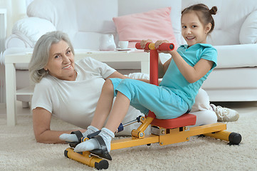 Image showing little granddaughter doing exercise