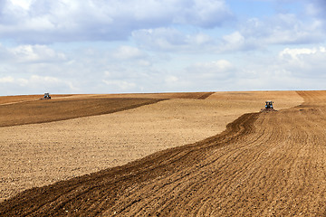 Image showing tractor plowing the fields  