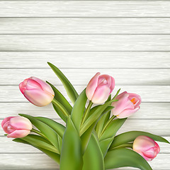 Image showing Beautiful pink tulips on wooden background. EPS 10 