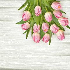 Image showing Beautiful pink tulips on wooden background. EPS 10