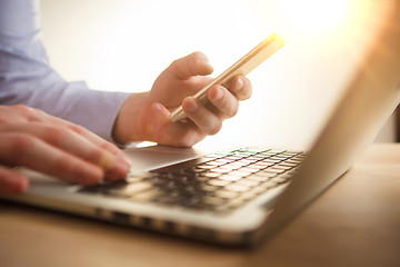 Image showing The male hand holding a phone 