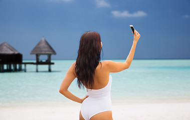 Image showing young woman taking selfie with smartphone