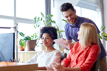 Image showing happy creative team with computer in office