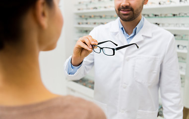 Image showing close up of optician with glasses at optics store