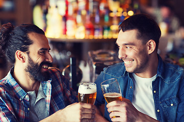 Image showing happy male friends drinking beer at bar or pub