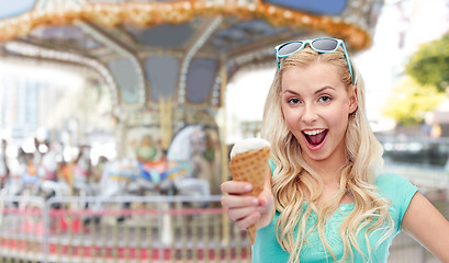 Image showing happy young woman in sunglasses eating ice cream