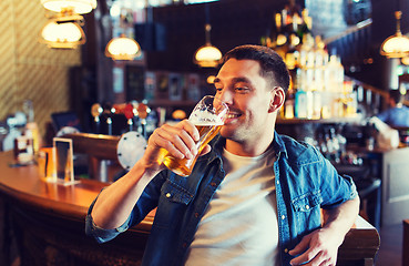 Image showing happy man drinking beer at bar or pub