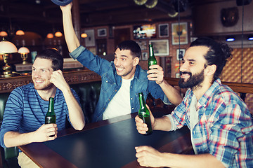 Image showing happy male friends drinking beer at bar or pub