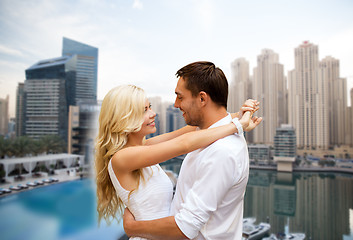 Image showing happy couple hugging over dubai city background