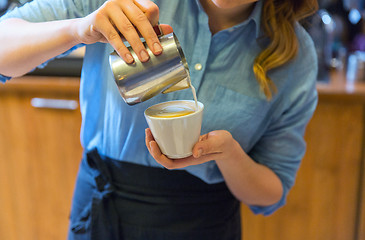 Image showing close up of woman making coffee at shop or cafe