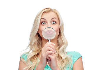 Image showing happy young woman with magnifying glass