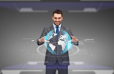 Image showing businessman with virtual earth globe projection