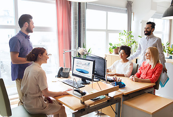 Image showing happy creative team talking in office