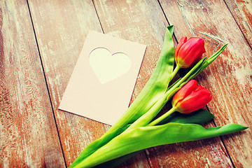 Image showing close up of tulips and greeting card with heart