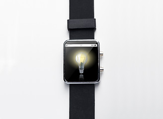 Image showing close up of smart watch with light bulb on screen