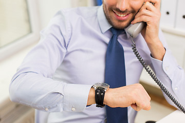 Image showing businessman dialing number and calling on phone