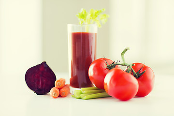 Image showing close up of fresh juice and vegetables on table