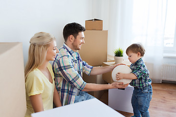 Image showing happy family moving to new home and playing ball