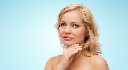 Image showing woman with bare shoulders touching face