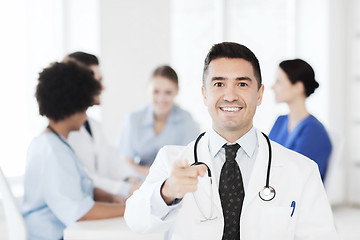 Image showing happy doctor over group of medics at hospital